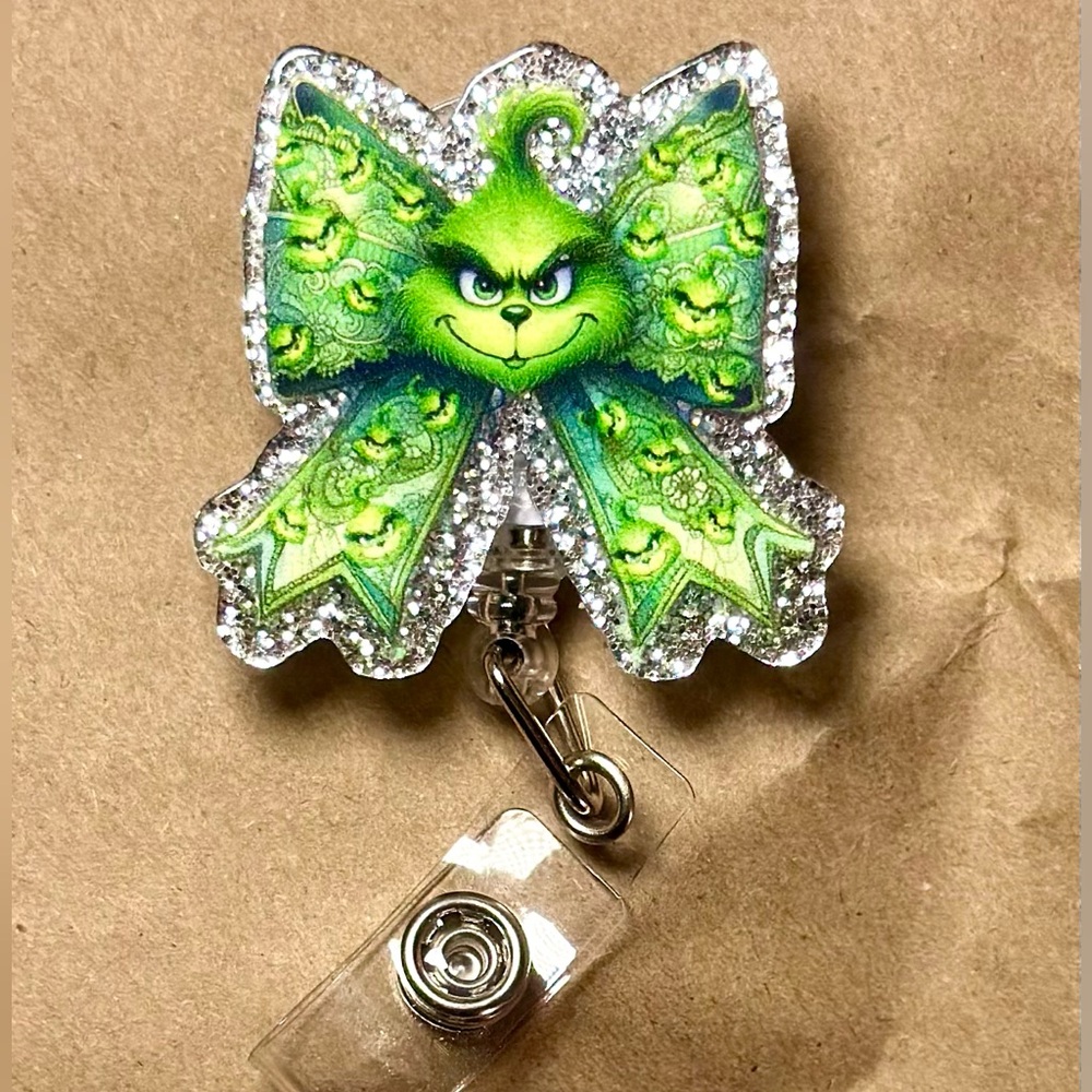 The Grinch on Christmas Themed Bow badge reel